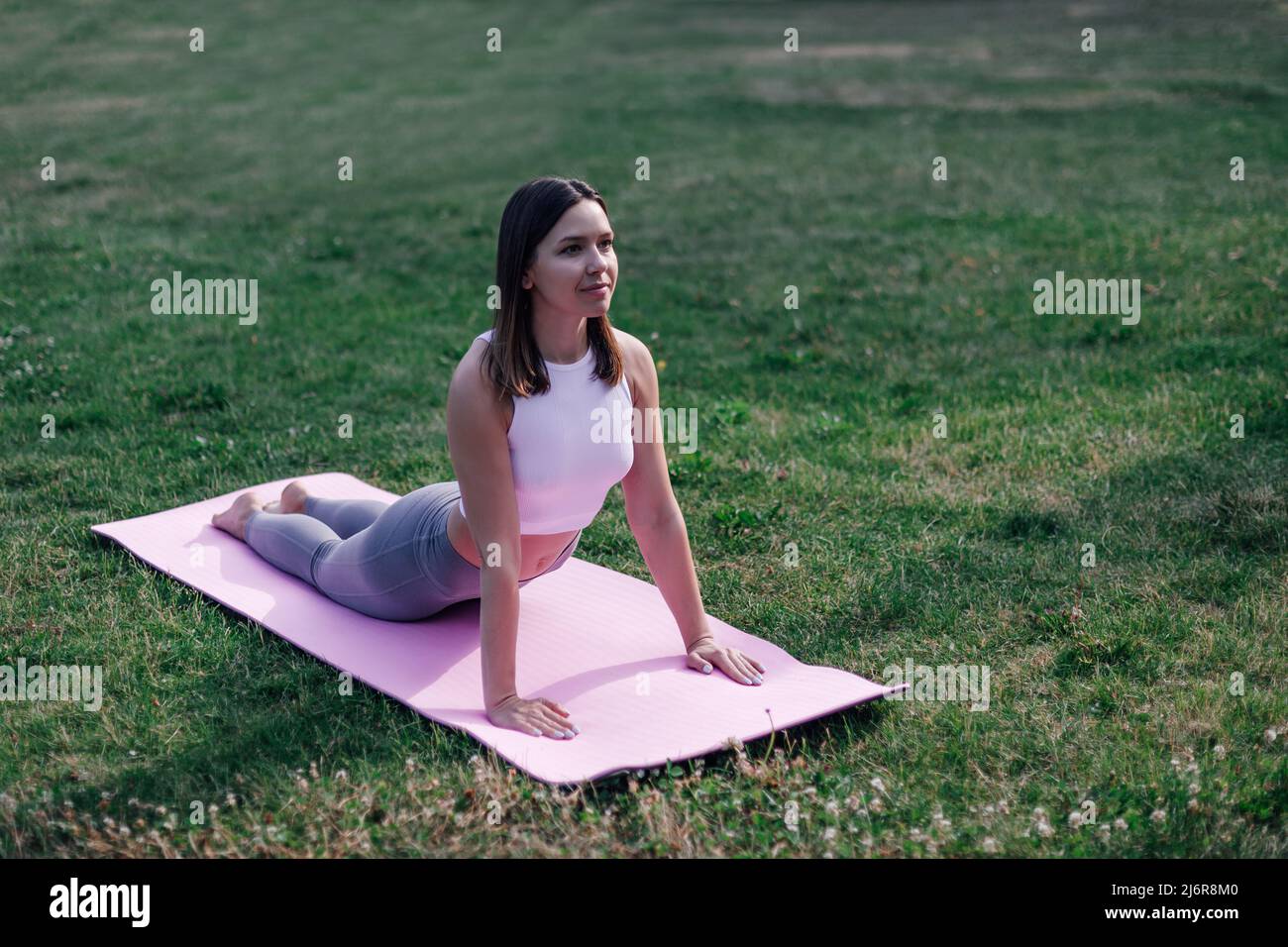 Young and Beautiful Woman Doing Yoga Exercises .Yoga Background Stock Photo  - Image of caucasian, park: 34501560