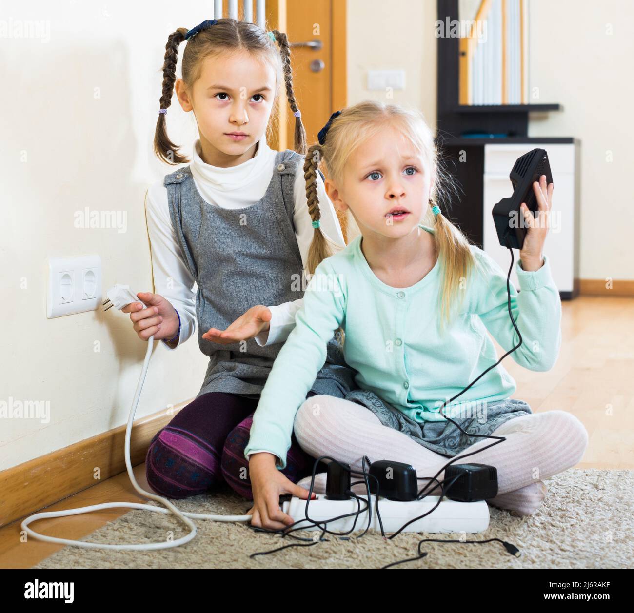 children playing with sockets and electricity indoors Stock Photo Alamy