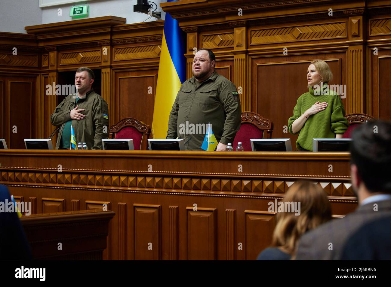 Kyiv, Ukraine. 03 May, 2022. Ukrainian Parliamentary leader Ruslan Stefanchuk, center, Deputy Chairperson Olena Kondratiuk, and First Deputy Chairman Oleksandr Kornienko, stands for the national anthem during a special session of the Verkhovna Rada or parliament, May 3, 2022 in Kyiv, Ukraine. British Prime Minister Boris Johnson delivered an unprecedented addressed the parliament via video conference calling the war “Ukraine’s Finest Hour”.  Credit: Ukraine Presidency/Ukraine Presidency/Alamy Live News Stock Photo