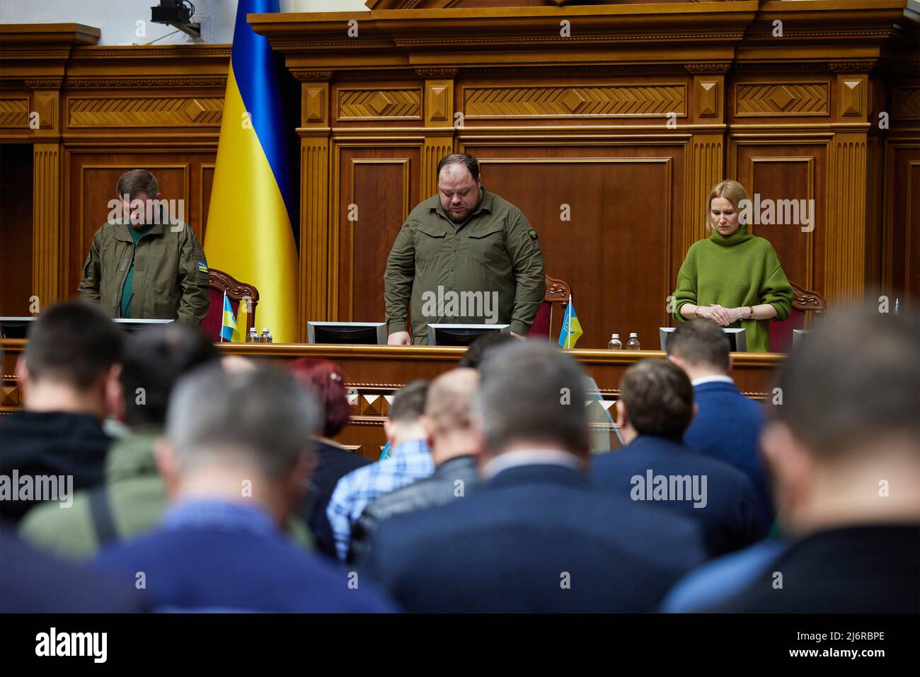 Kyiv, Ukraine. 03 May, 2022. Ukrainian Parliamentary leader Ruslan Stefanchuk, center, Deputy Chairperson Olena Kondratiuk, and First Deputy Chairman Oleksandr Kornienko, bow their heads for the invocation during a special session of the Verkhovna Rada or parliament, May 3, 2022 in Kyiv, Ukraine. British Prime Minister Boris Johnson delivered an unprecedented addressed the parliament via video conference calling the war “Ukraine’s Finest Hour”.  Credit: Ukraine Presidency/Ukraine Presidency/Alamy Live News Stock Photo