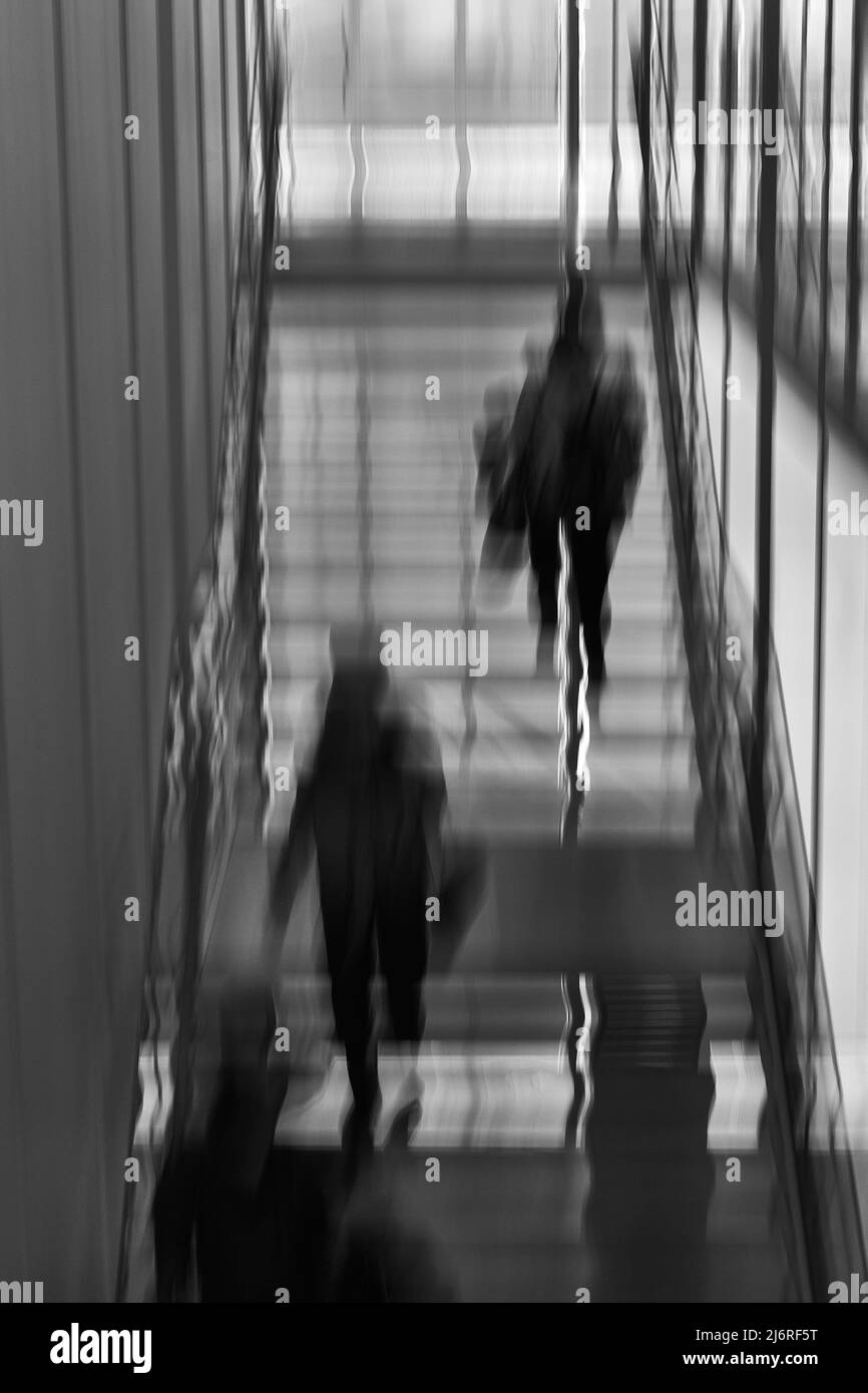abstract image of movement of a group climbing up interior stairs Stock Photo