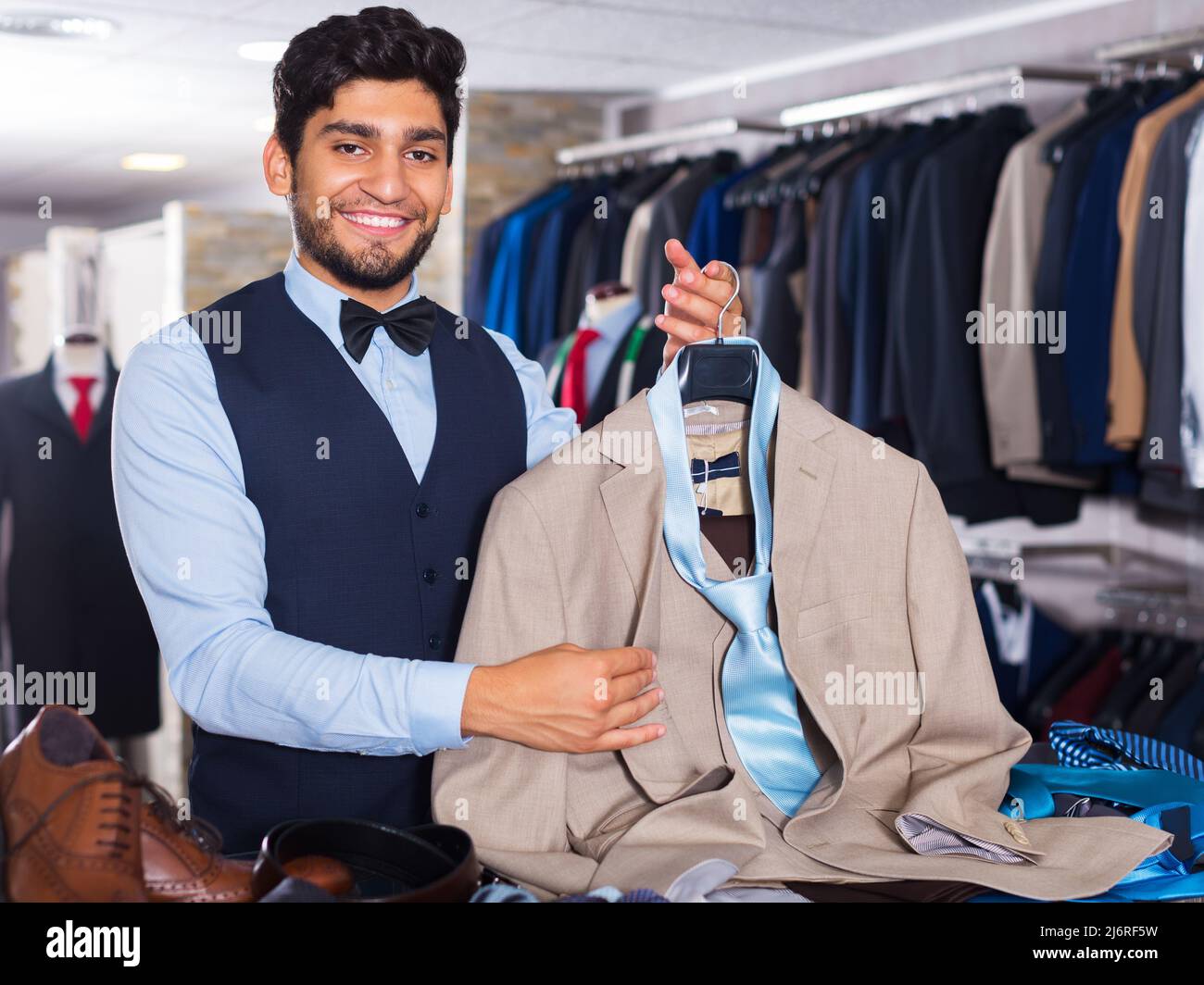 Man demonstrating suit in shop Stock Photo - Alamy