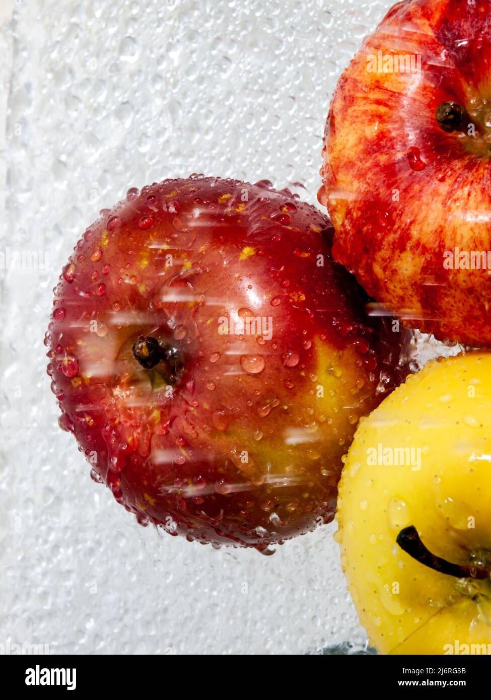 Three Apples with splashing water Stock Photo