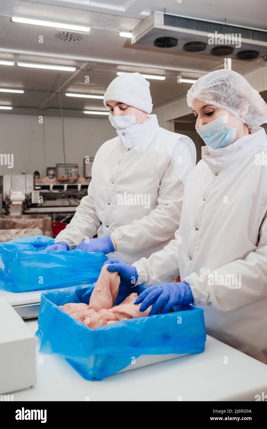 Automated production line with packaging and cutting of meat in modern food factory.Meat