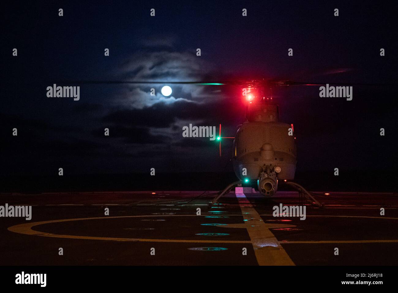220416-N-NK931-882 PACIFIC OCEAN (April. 16, 2022) – An MQ-8C Fire Scout unmanned helicopter assigned to  the “Wildcards” of Helicopter Sea Combat Squadron (HSC) 23 prepares to launch during night flight operations on the flight deck of Independence-variant littoral combat ship USS Montgomery (LCS 8). LCS is a fast, agile, mission-focused platform designed to operate in near-shore environments, winning against 21st-century coastal threats. LCS is capable of supporting forward presence, maritime security, sea control, and deterrence.  (U.S. Navy photo by Lt. j.g. Samuel Hardgrove) Stock Photo