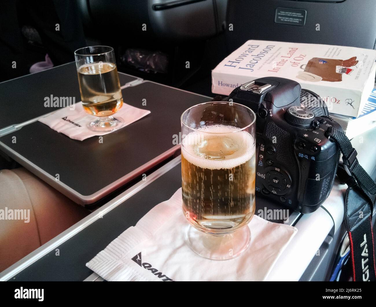 Have camera will travel - settled into business class on Quantas with wine a camera and a good book Los Angeles CA USA 11 24 2013 Stock Photo