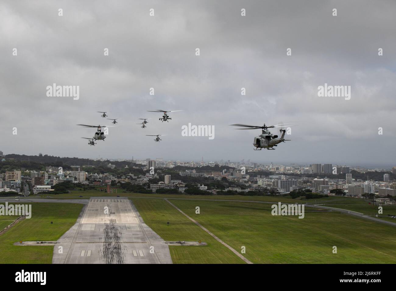 U.S. Marines with Marine Light Attack Helicopter Squadron (HMLA) 369 fly in formation during a training exercise at Ie Shima, Okinawa, Japan, April 29, 2022. HMLA-369 successfully launched multiple aircraft for a single flight as a display of appreciation for the hard work of the squadron. Stock Photo