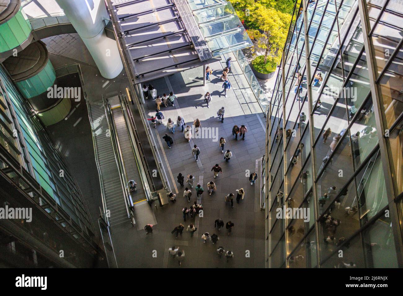 Overhead view of people walking between modern buildings Stock Photo