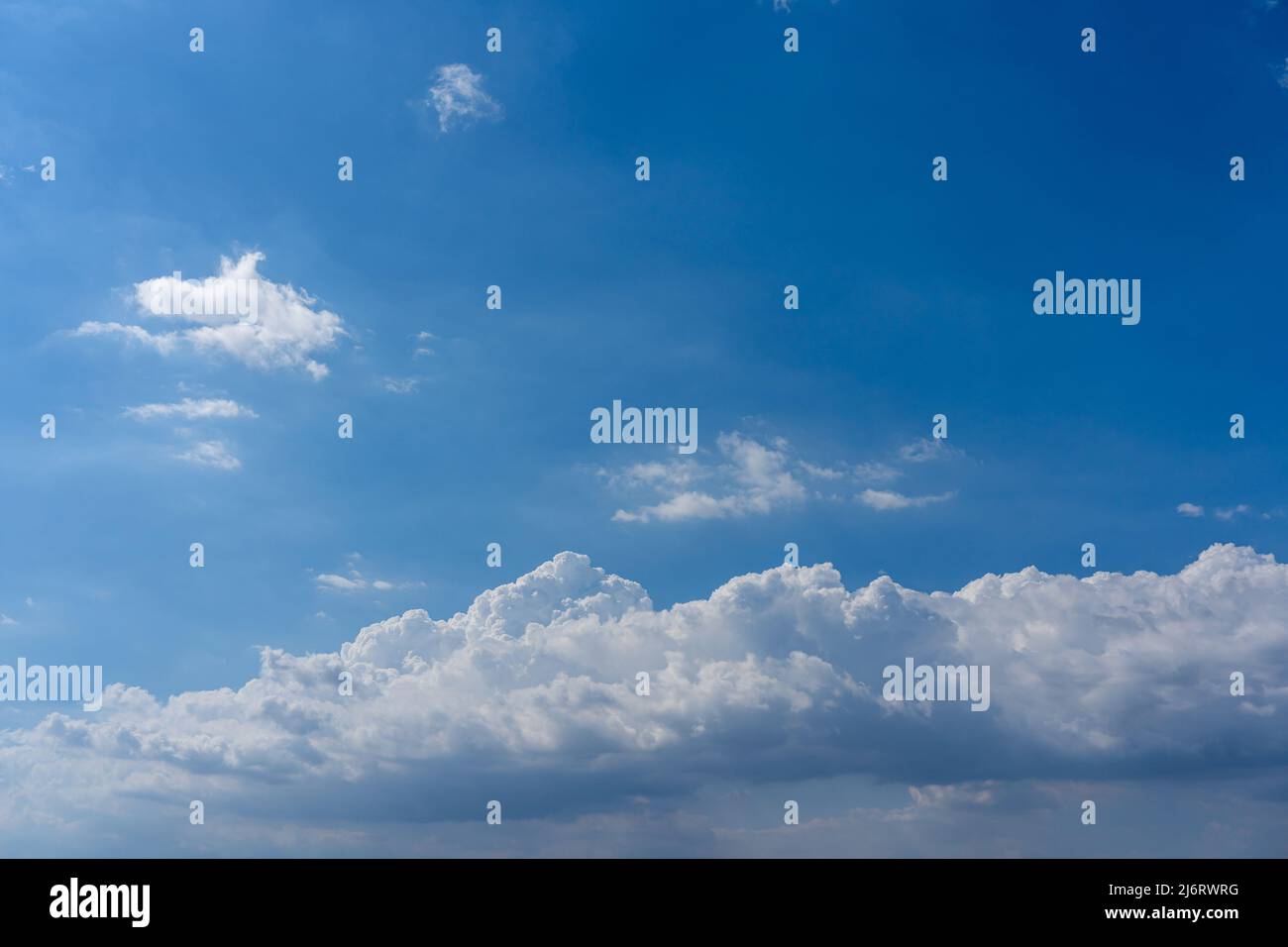White cumulus clouds floating in the blue sky Stock Photo