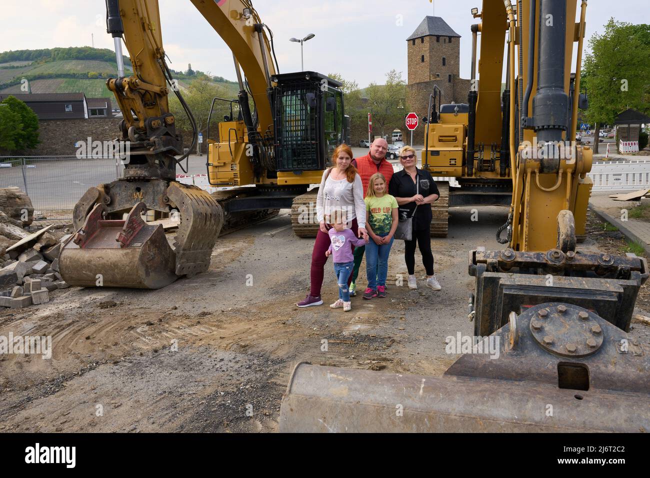 02 May 2022, Rhineland-Palatinate, Ahrweiler: Valentyna Ridvanskaya (m) and her family, husband Yuri (r), mother-in-law Svitlana, and children Polina and Uliana, stand in front of the remains of the Ahrtor Bridge. The family is from near Kiev and recently fled the war in Ukraine. At the moment, the family is helping out with the aid organization 'Ark', which cares for people affected by the flood disaster. Photo: Thomas Frey/dpa Stock Photo