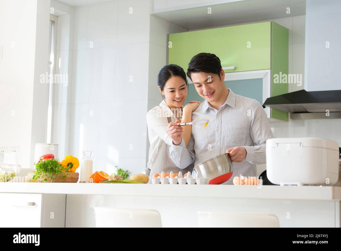Young couple preparing food in the family kitchen - stock photo Stock Photo