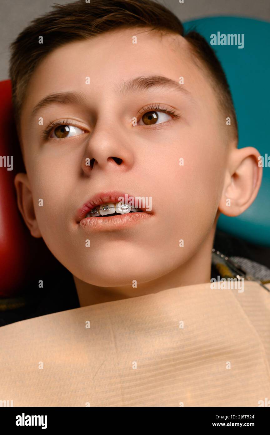 regular visit to the orthodontist of the patient with braces, braces on