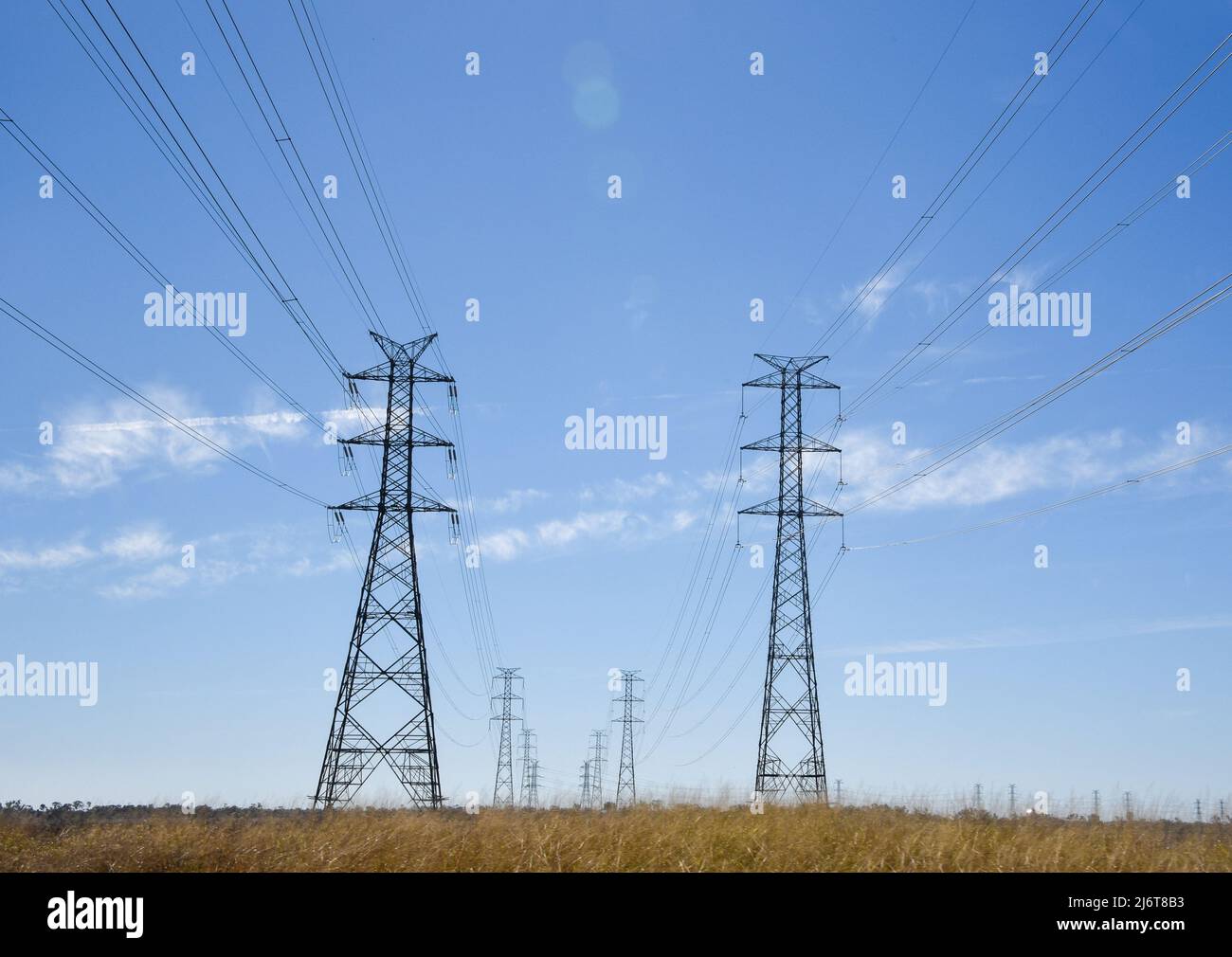 High voltage electrical power transmission lines with blue sky and some ...
