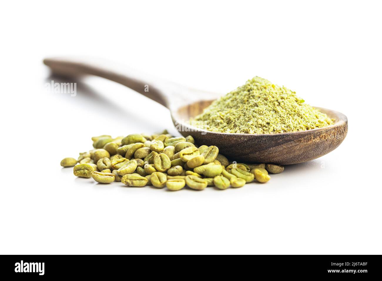Ground green coffee and coffee beans in wooden spoon. Unroasted coffee isolated on a white background. Stock Photo