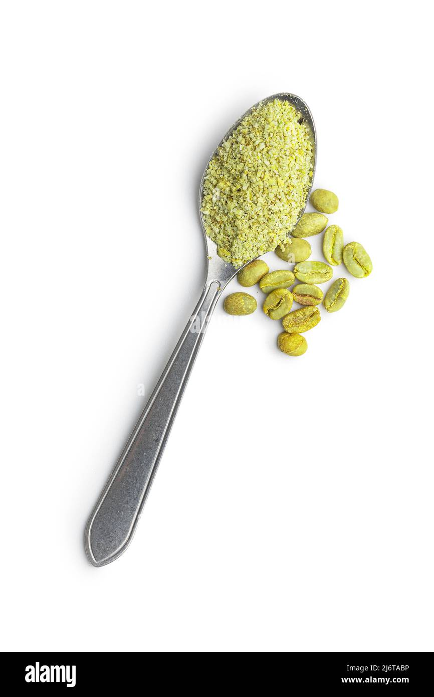 Ground green coffee and coffee beans in spoon. Unroasted coffee