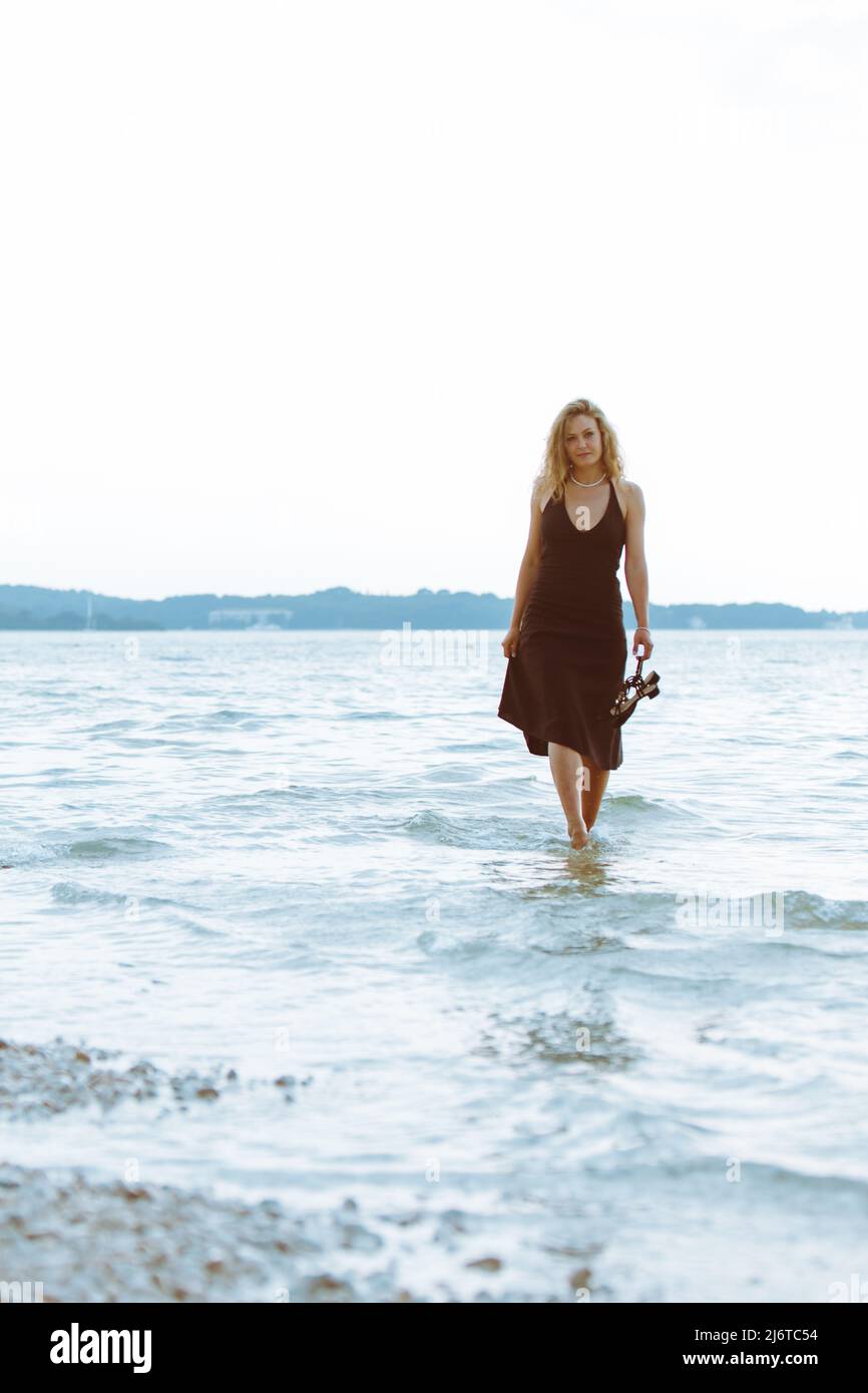 woman in black light dress walking barefoot by sea beach warm summer evening Stock Photo - Alamy woman in black light dress walking barefoot by sea beach warm summer evening Stock Photo - Alamy