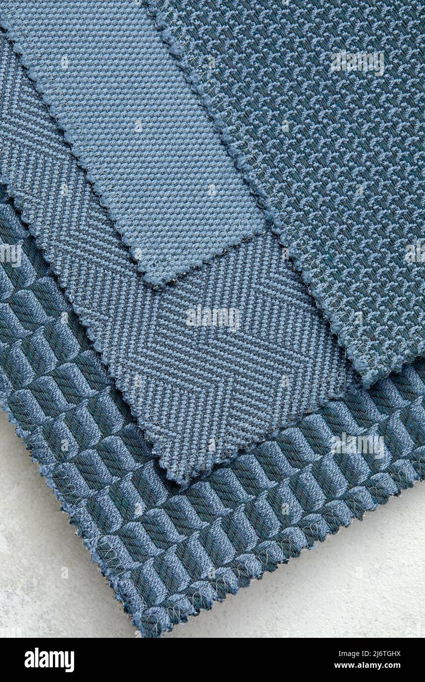 The background consists of several types of old colored tiles with different patterns on blue tone Stock Photo