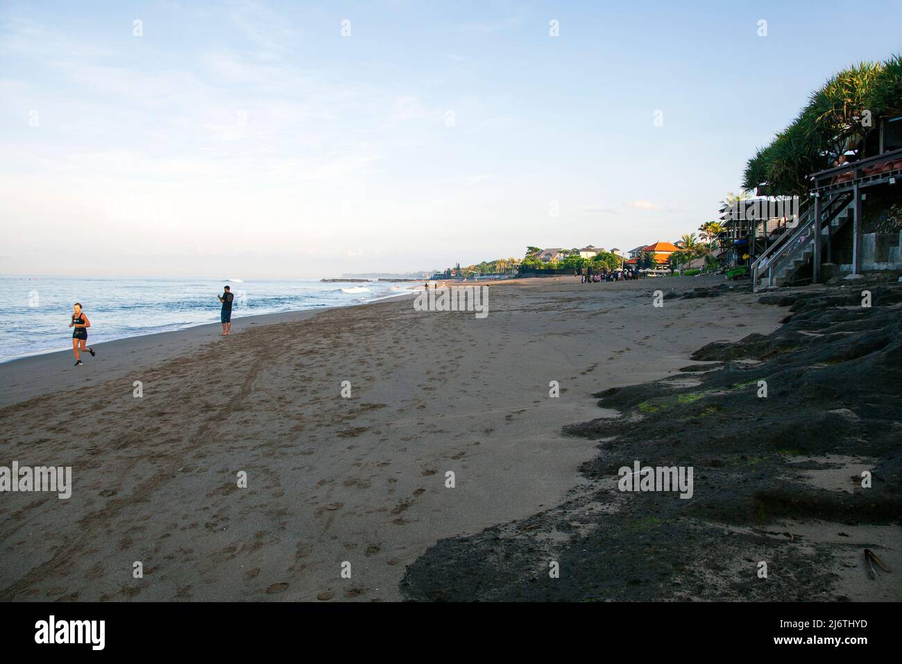 View of Batu Bolong Beach in Canggu Bali with people walking and jogging in the early morning. Stock Photo