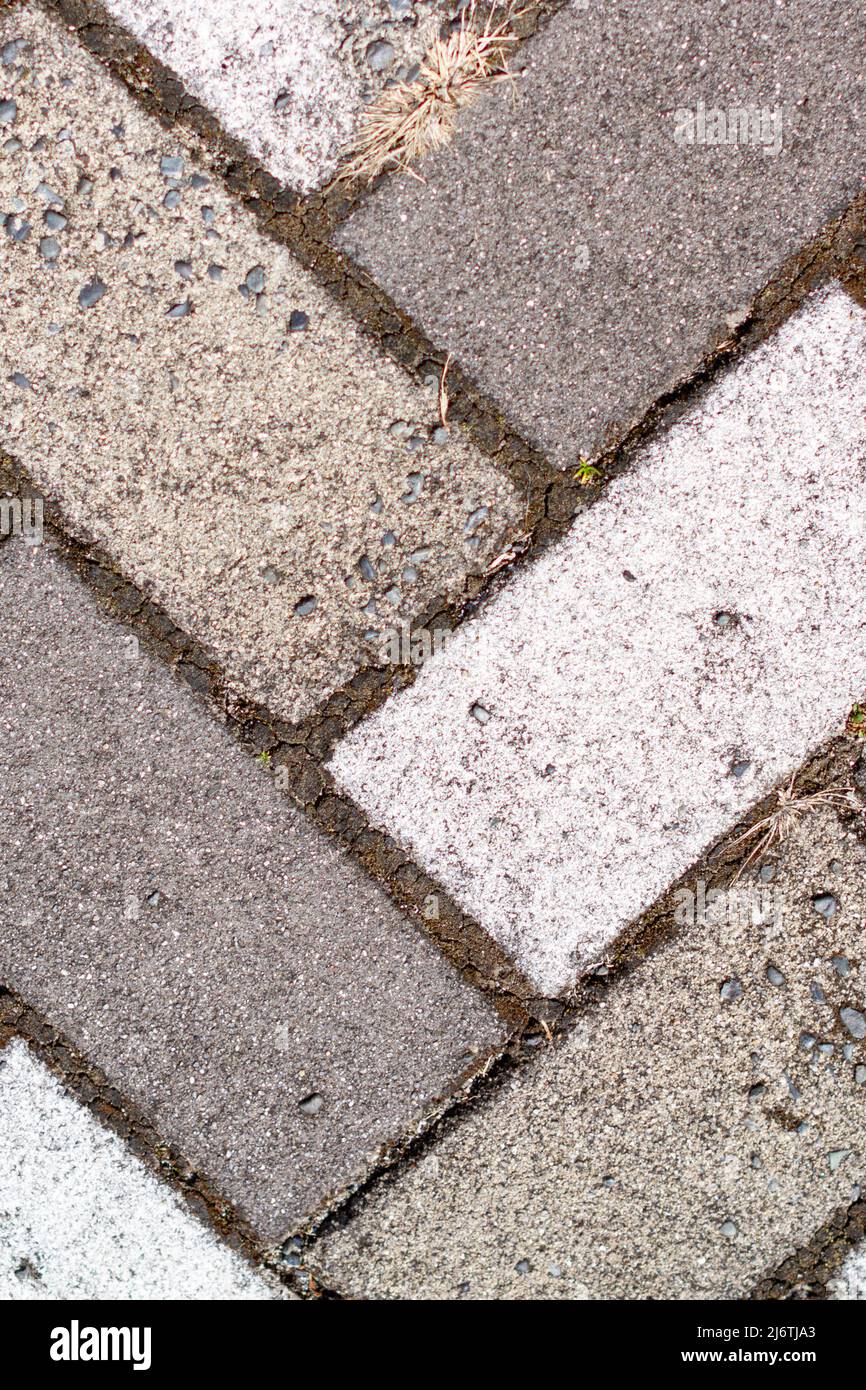 Closeup of sidewalk paved with rectangular white and gray tiles in top view. Stock Photo