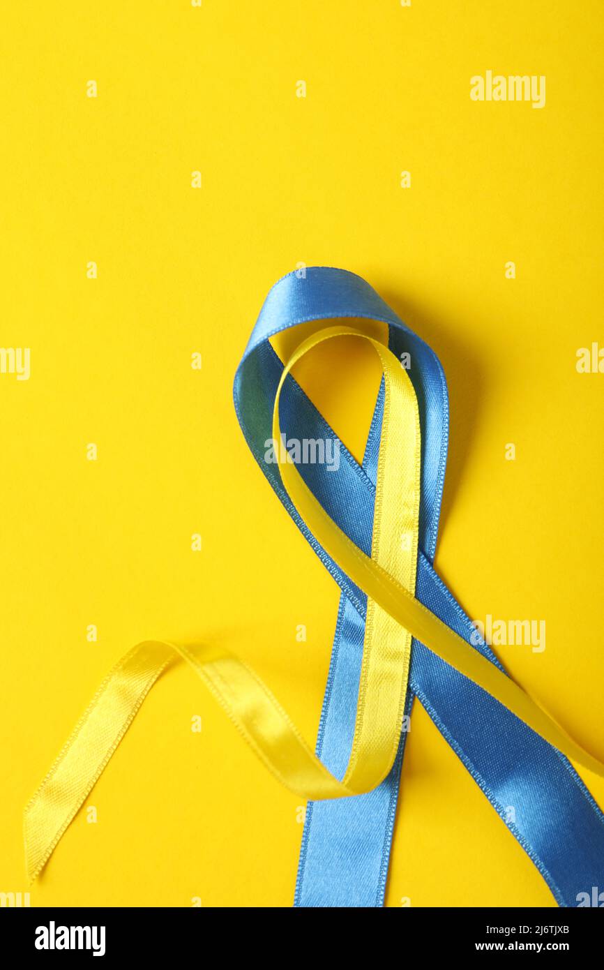 Ukraine Ribbon Support Support Ukraine concept, blue and yellow awareness ribbons on yellow ...