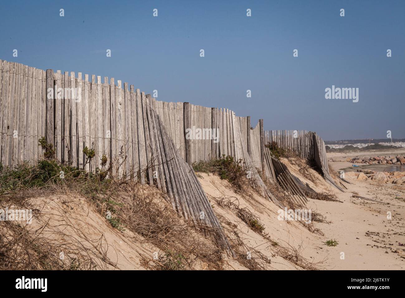 a broken wooden fence on a little island in the Natural reserve of Ria Farmosa near Tavira, Portugal at the Algarve Stock Photo