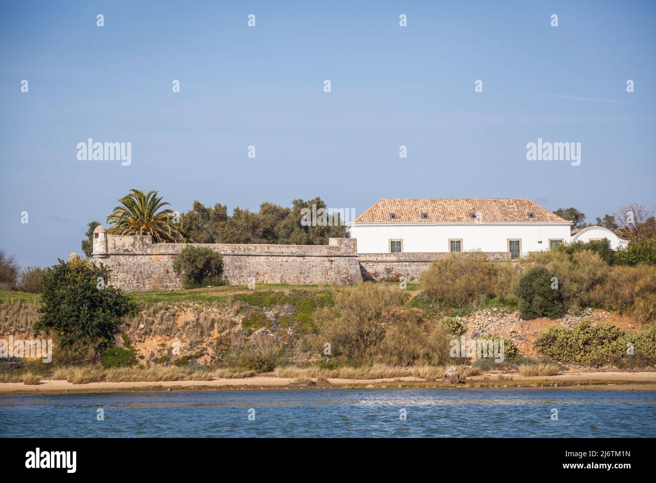 View from the solar boat on an old but newly renovated villa in the middle of the Ria Farmosa nature reserve on the Algarve in Portugal Stock Photo