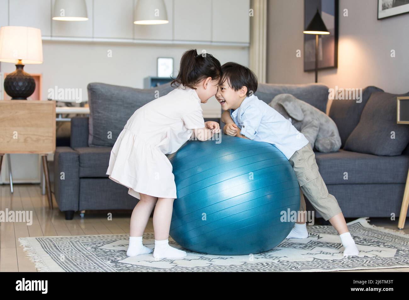A boy and a girl playing intimately in the living room of their home - stock photo Stock Photo