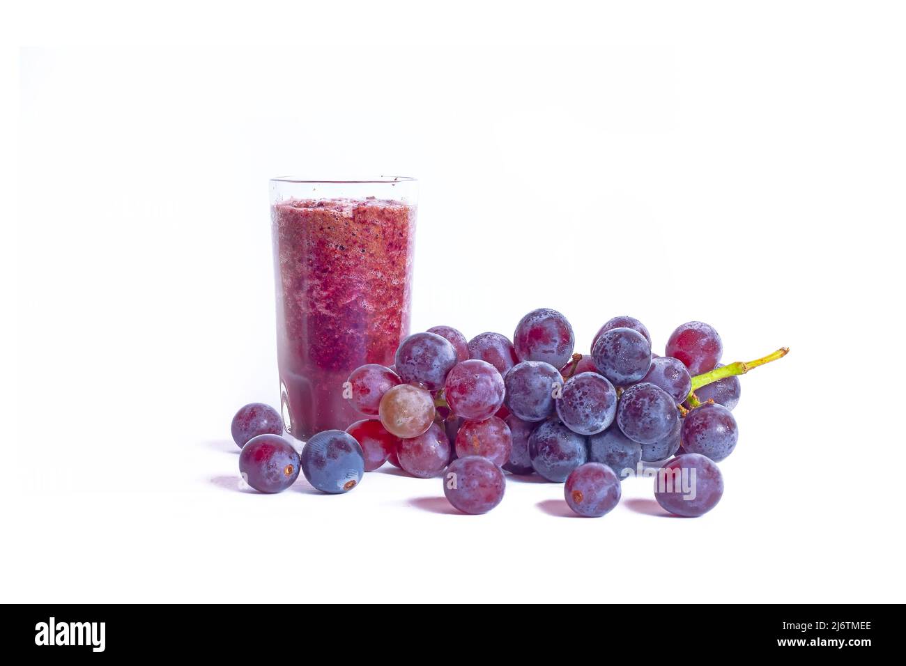 A glass of grape juice with bunch of grapes fruits isolated on white ...