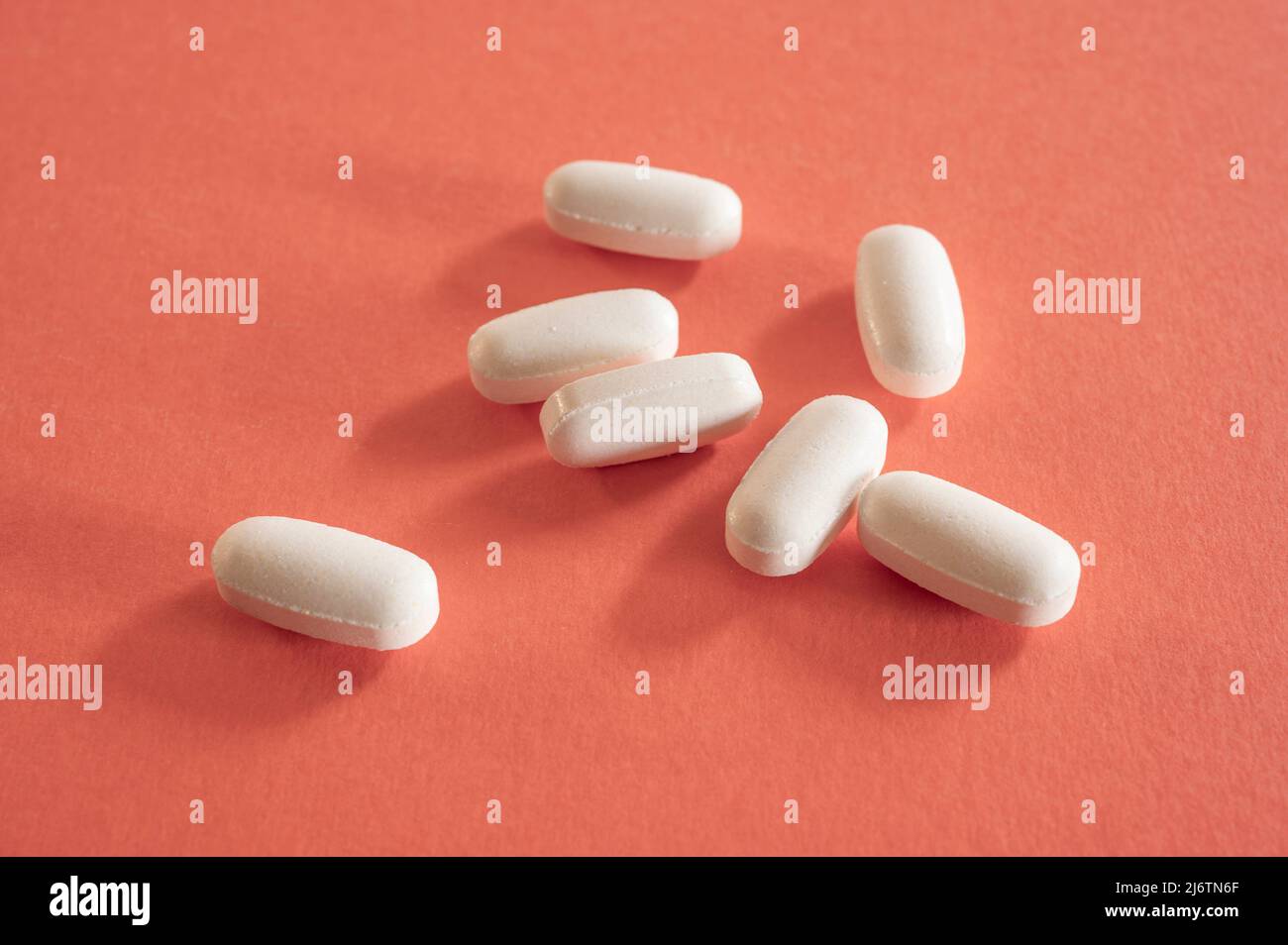 Closeup of with pills on red background Stock Photo