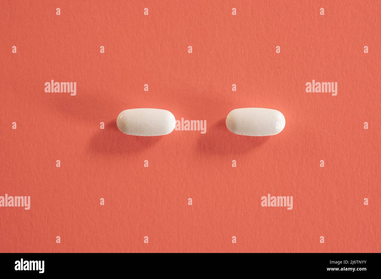 Closeup of with pills on red background Stock Photo