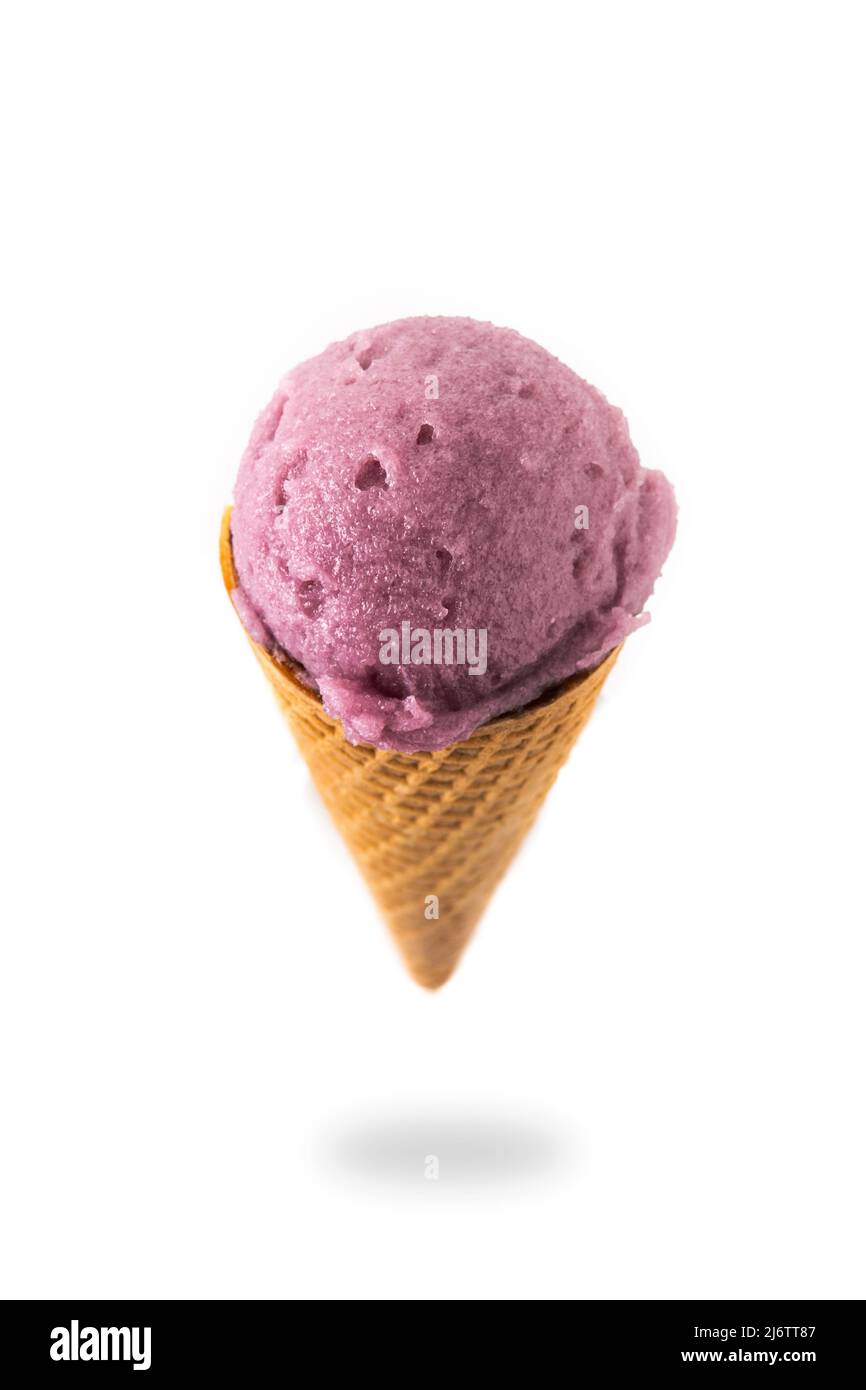 Blueberry ice cream cone floating in the air isolated on white ...