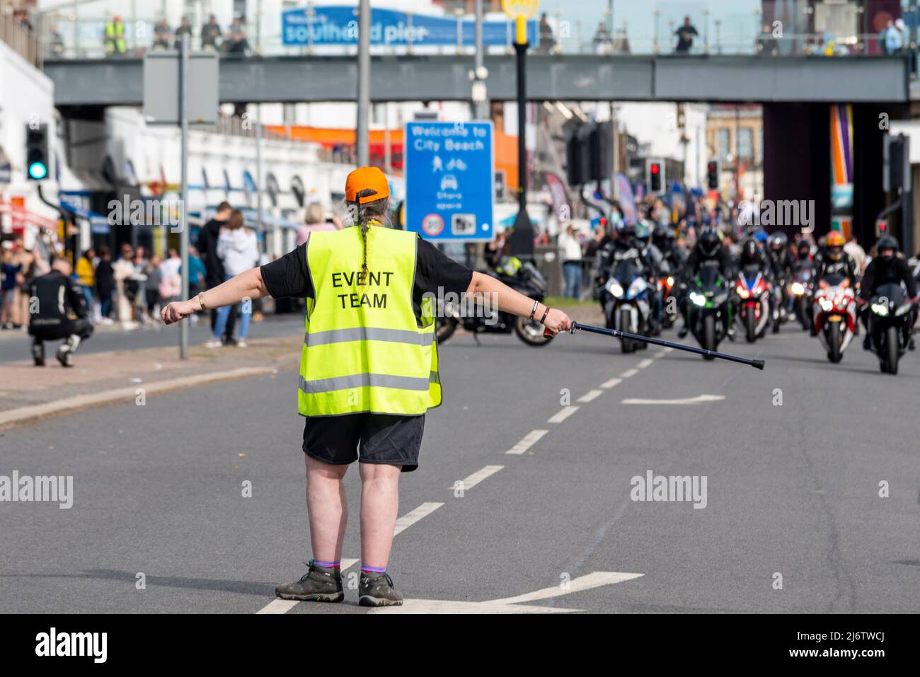 Event team member directing motorbikes at the Southend Shakedown 2022 motorcycle event on Easter Bank Holiday Monday in Southend on Sea, UK. Stock Photo
