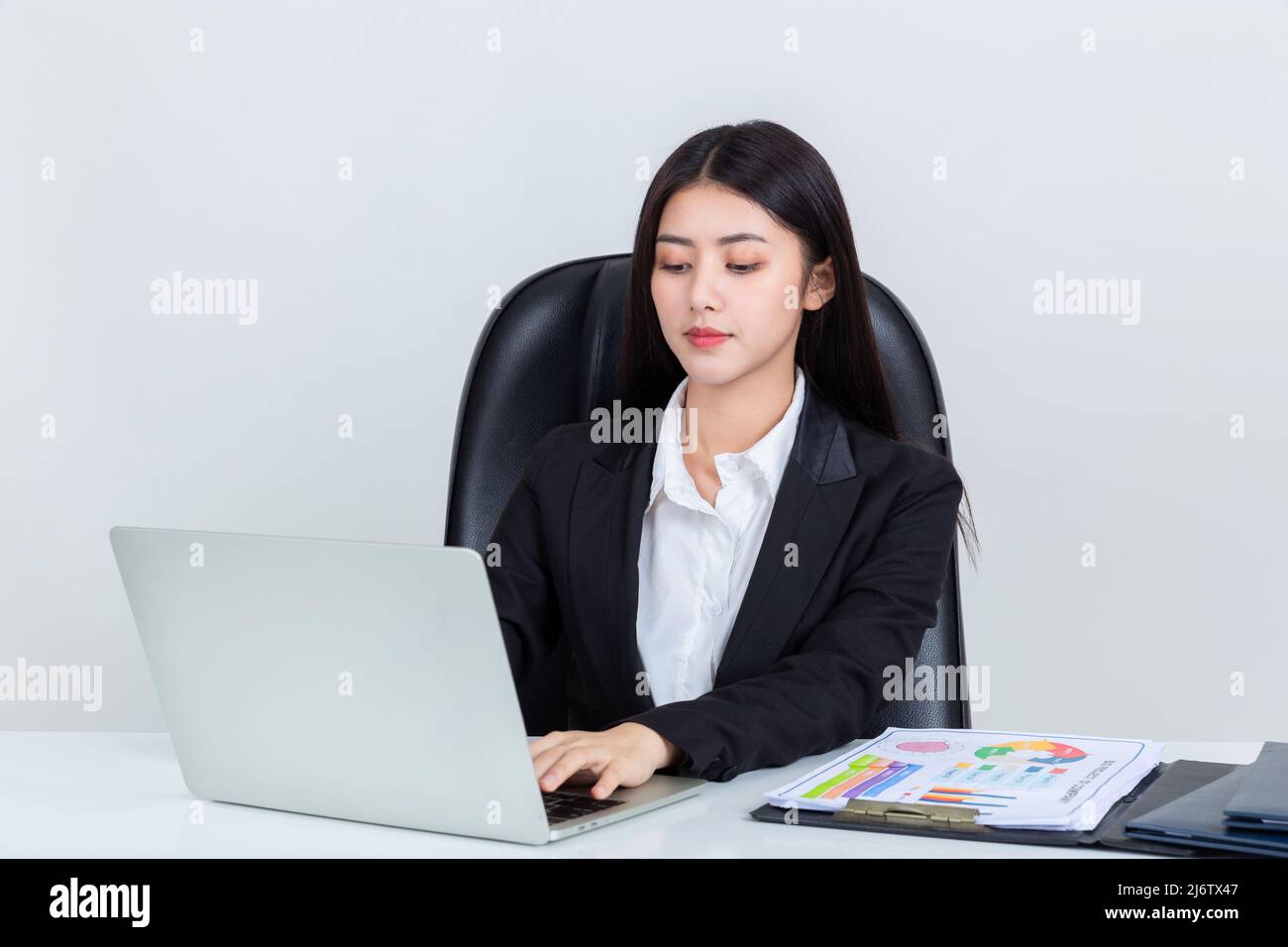 Asian business woman sit at desk in office Stock Photo - Alamy