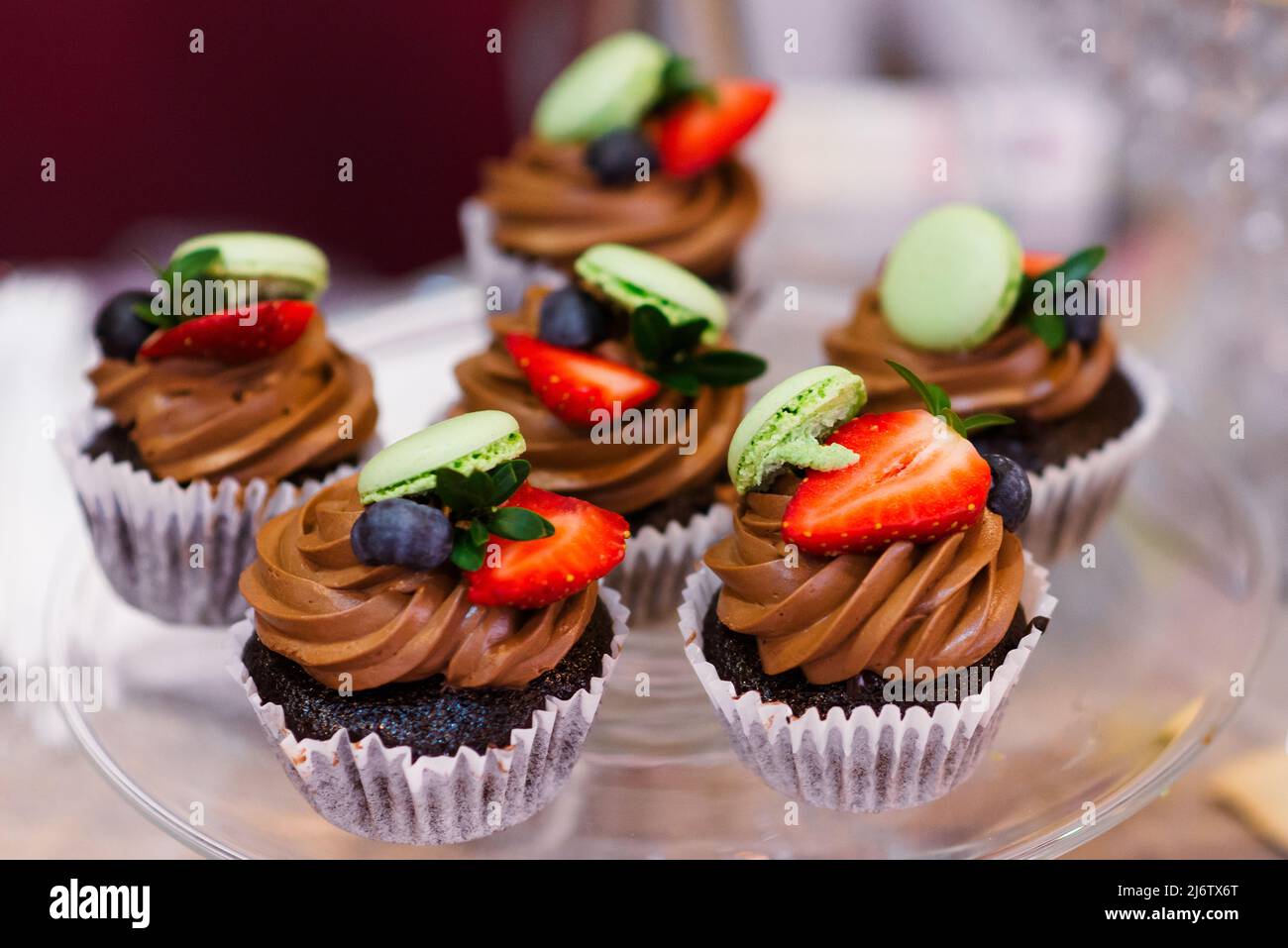Multi-colored cakes and sweets on the festive table Stock Photo