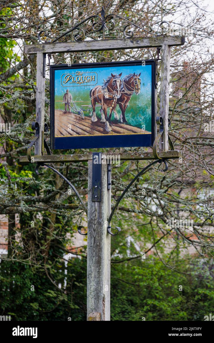 Traditional pole-mounted painted pub sign outside The Plough, a pub Shalbourne, a small unspoilt village in rural Wiltshire, England Stock Photo