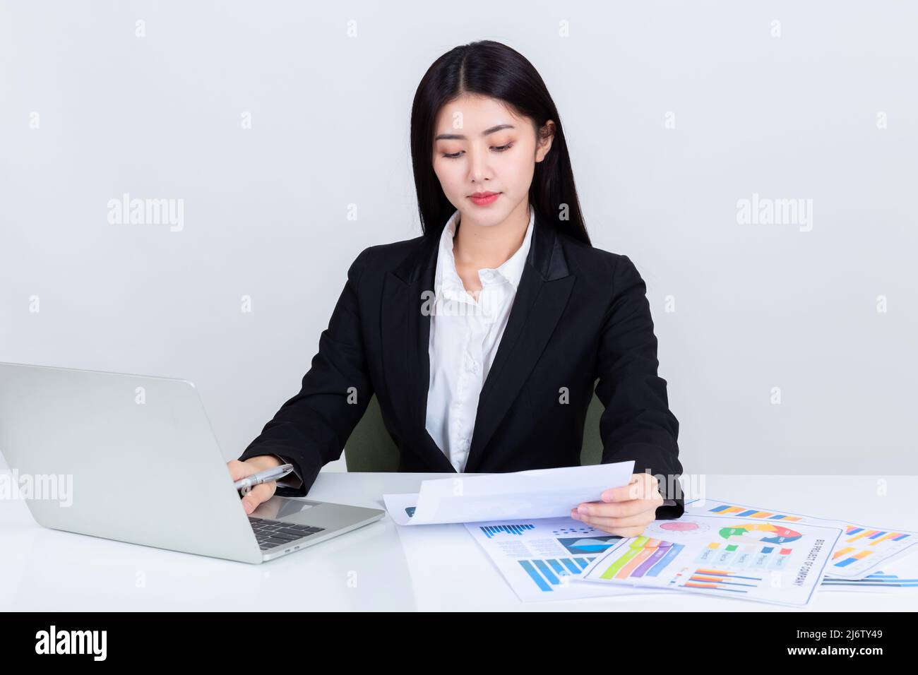 Asian business woman sit at desk in office Stock Photo - Alamy