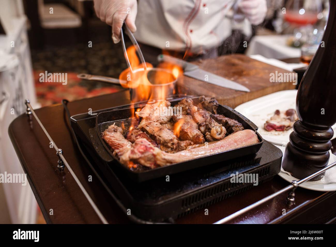 Hand of grilling some meat and meat ball on hot flame Stock Photo Alamy