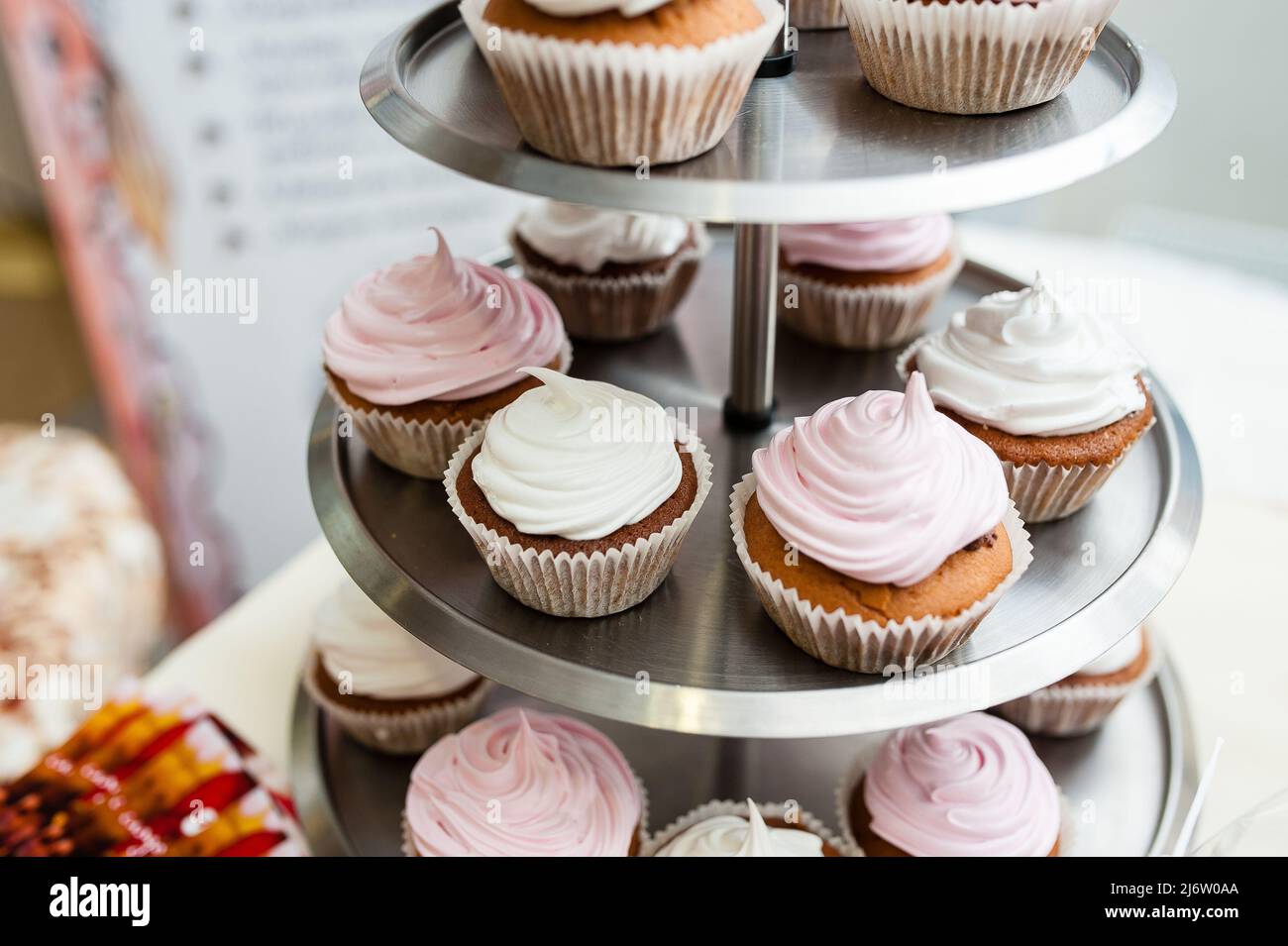 Multi-colored cakes and sweets on the festive table. Stock Photo