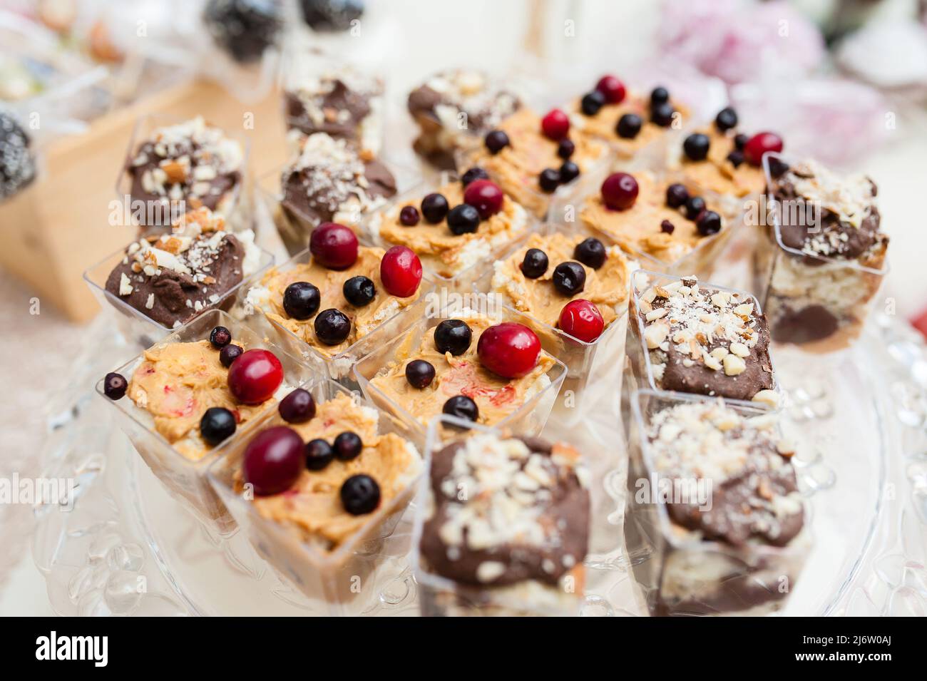 Multi-colored cakes and sweets on the festive table. Stock Photo