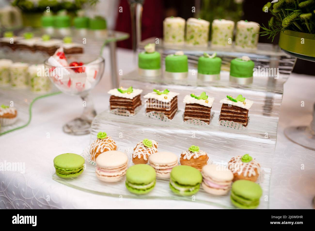 Multi-colored cakes and sweets on the festive table. Stock Photo