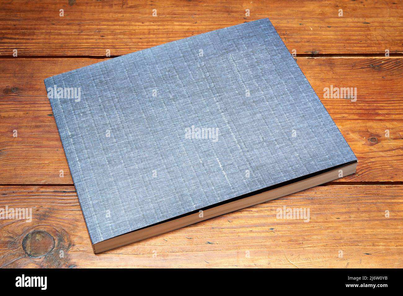 Textured cover of book on old-fashionable wooden desk Stock Photo