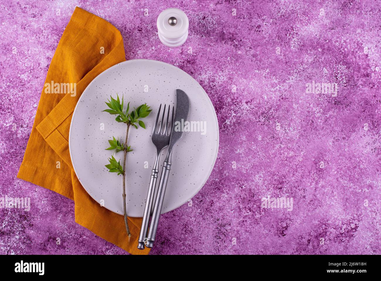 Table setting on lilac concrete background Stock Photo