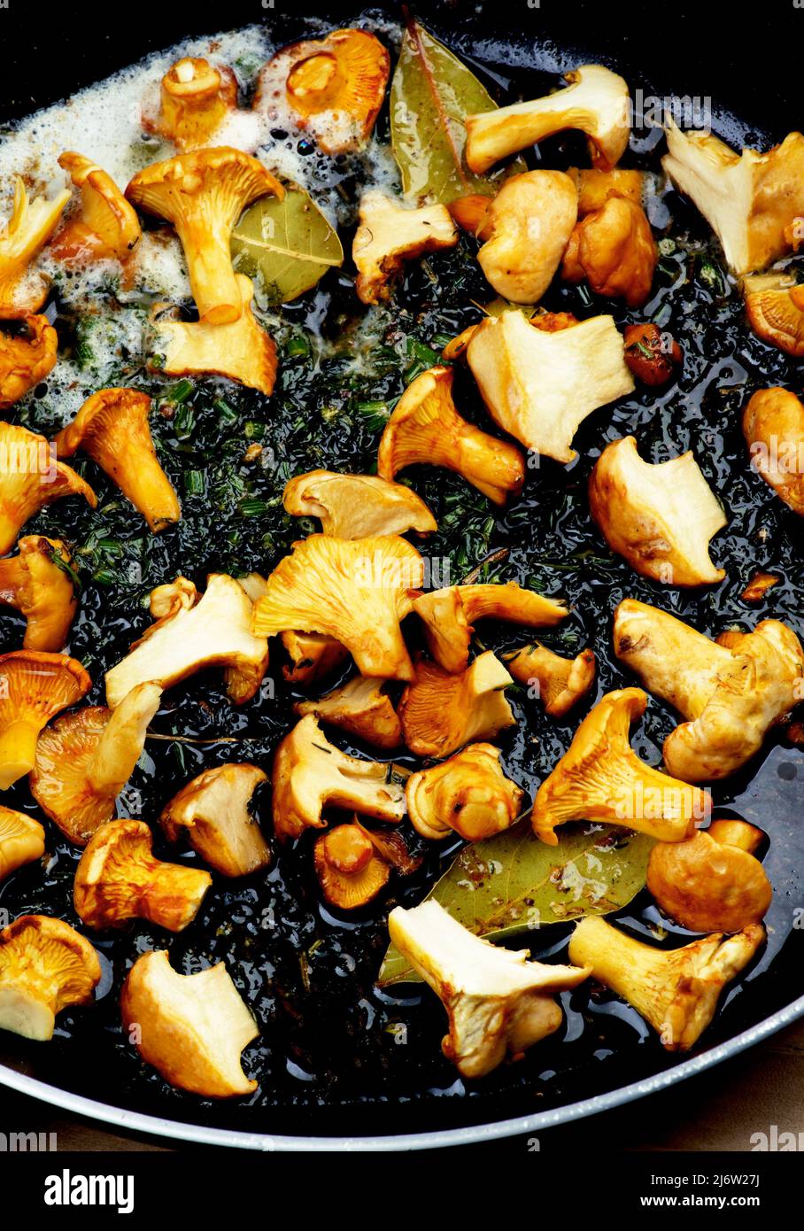 Small Chanterelles Mushrooms Fried with Butter and Spices closeup in