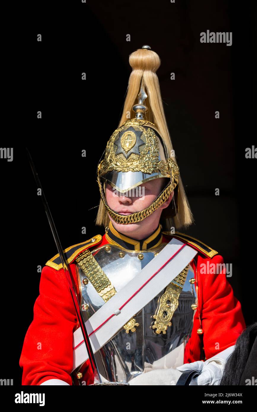 British Army Life Guards of Household Cavalry soldier on ceremonial mounted guard duty at Horse Guards, London, UK. Polished helmet and cuirass plate Stock Photo