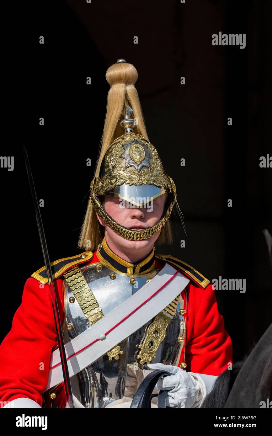 British Army Life Guards of Household Cavalry soldier on ceremonial mounted guard duty at Horse Guards, London, UK. Polished helmet and cuirass plate Stock Photo
