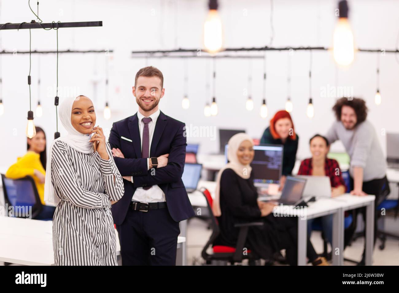 Two multiethnic colleagues in a modern office space. Group of people ...