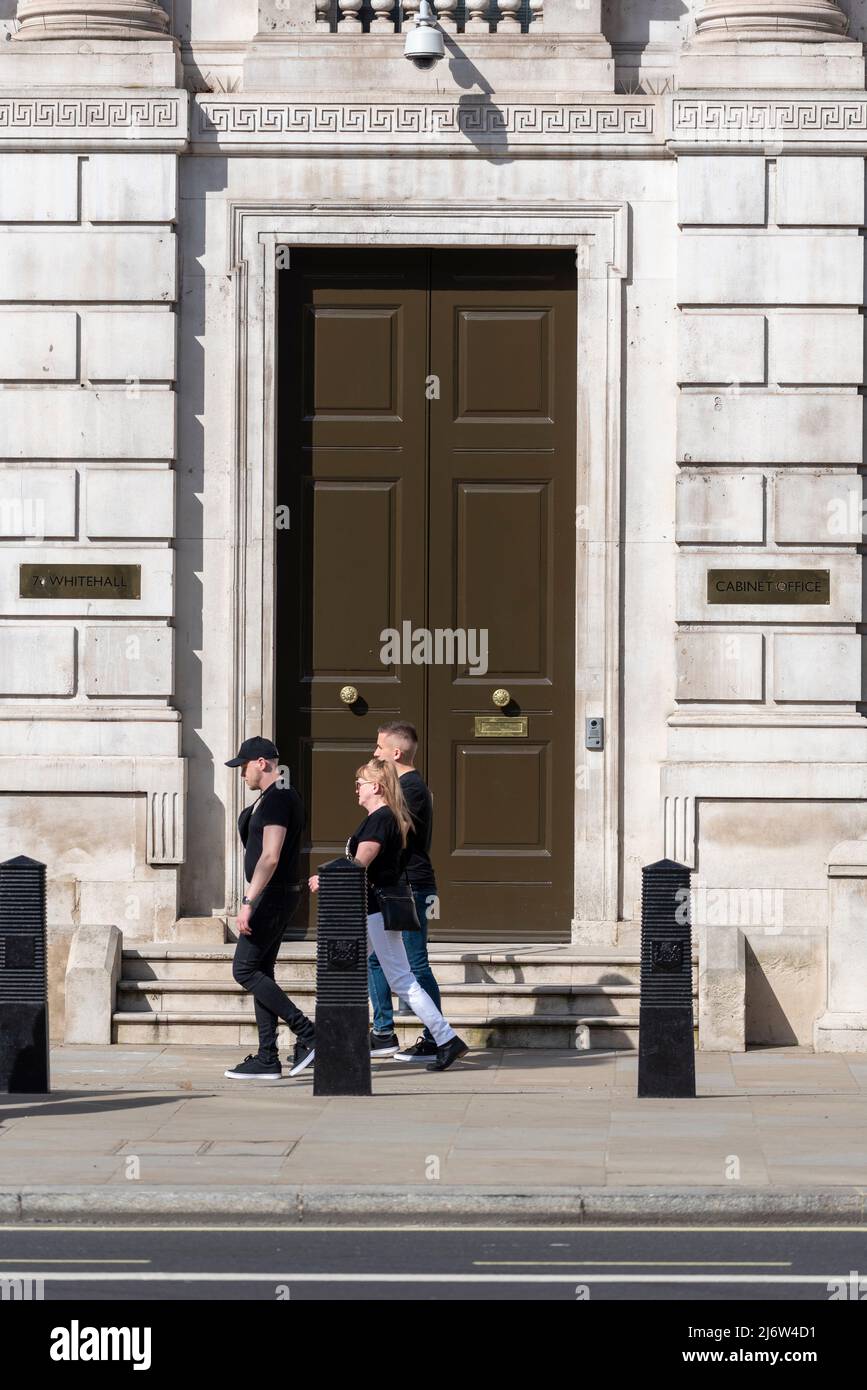Office door in 70 Whitehall, Westminster, London, UK. People