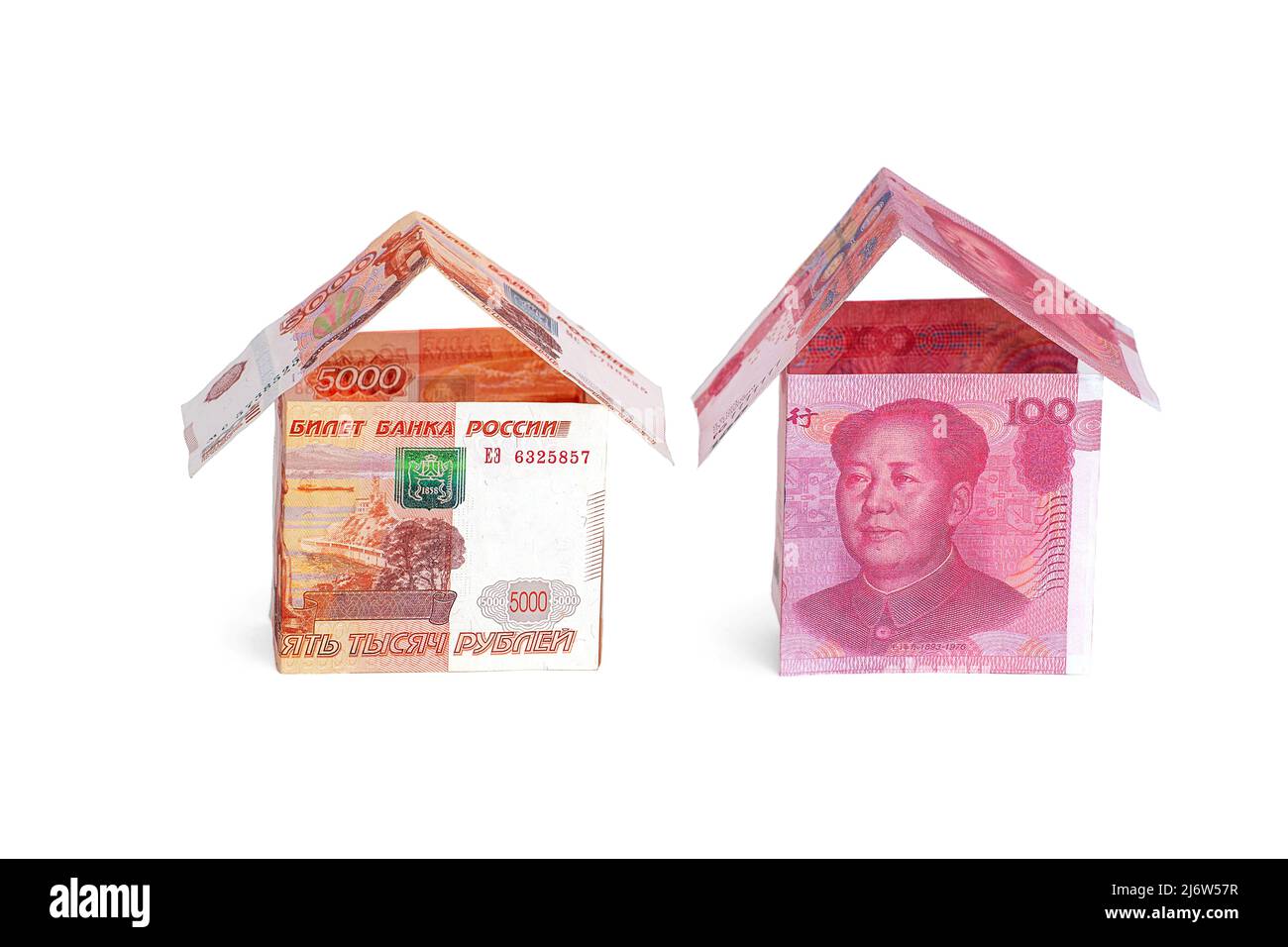 Money houses made of rubles and yuan, isolated on a white background Stock Photo