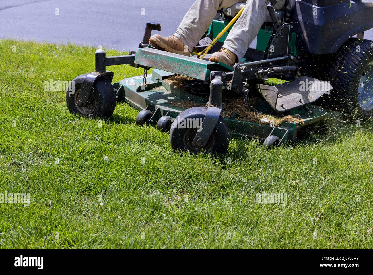 Lawn mower cutting green grass in backyard, mowing lawn Stock Photo - Alamy