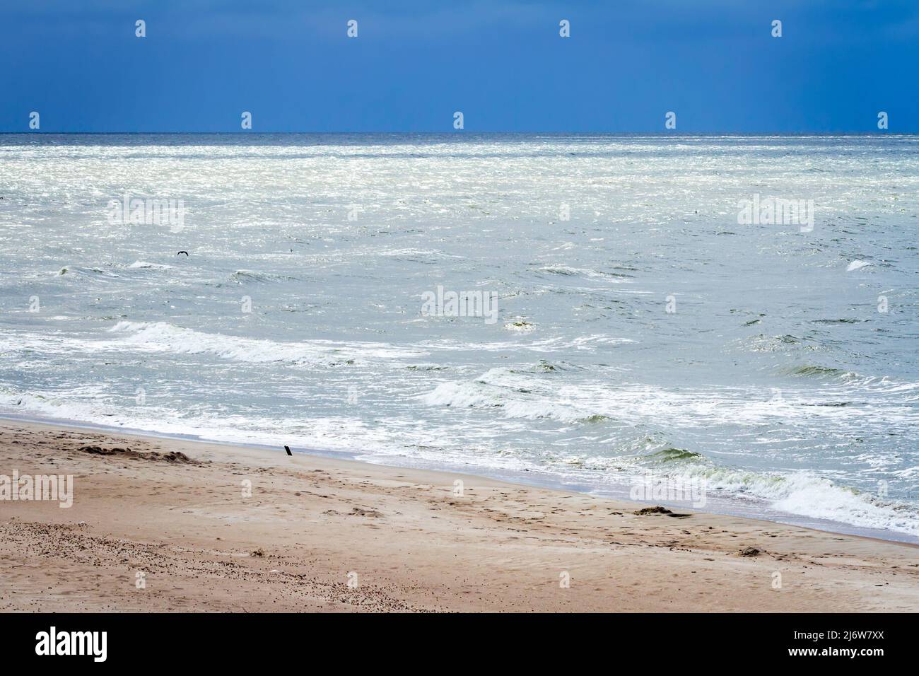 Soft waves of the sea on the sandy beach Stock Photo